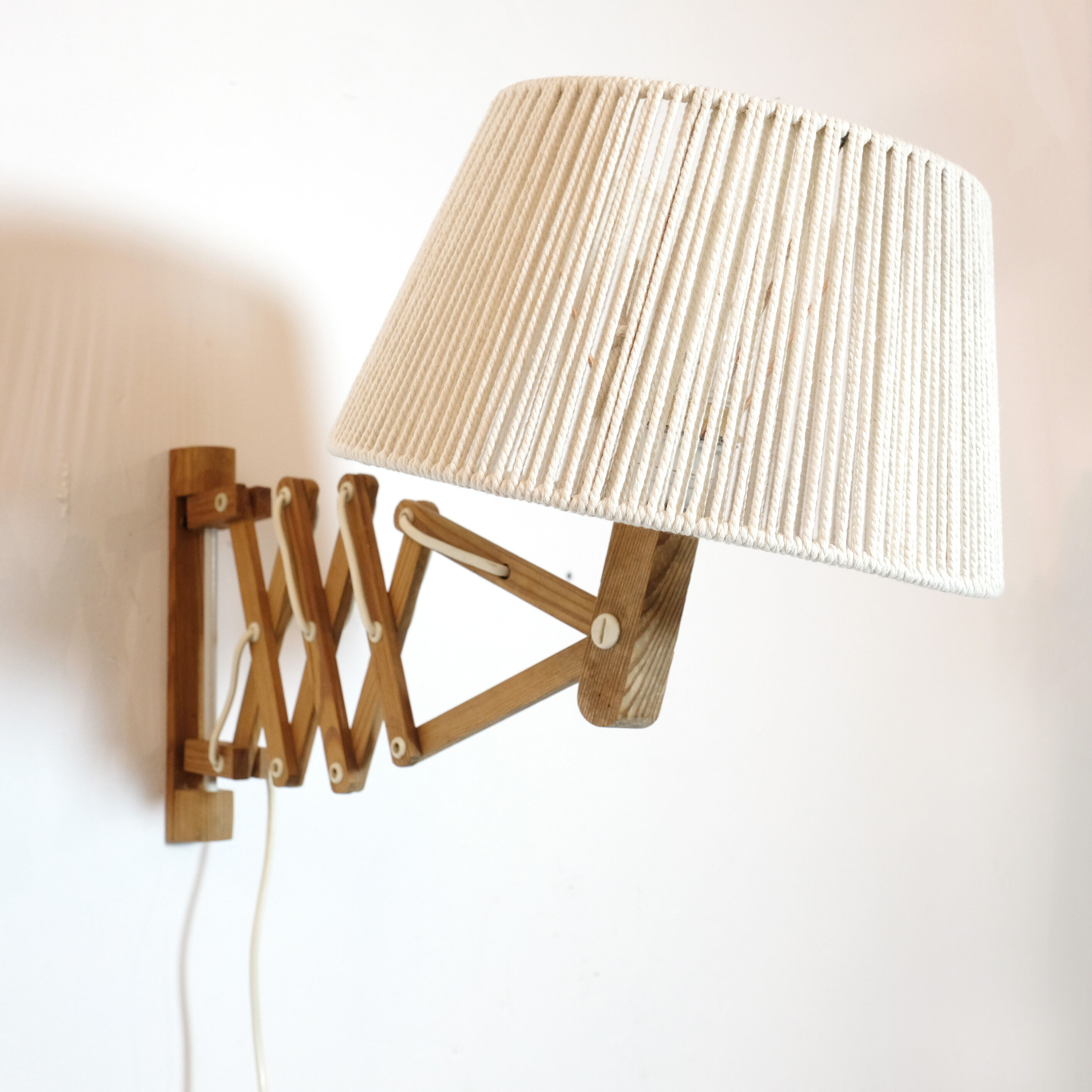 Pair of pine accordion sconces with cotton rope lampshade.