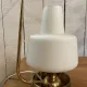 Table lamp in gold metal and opaline.