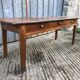 Antique chestnut farmhouse table with 3 drawers on the front.