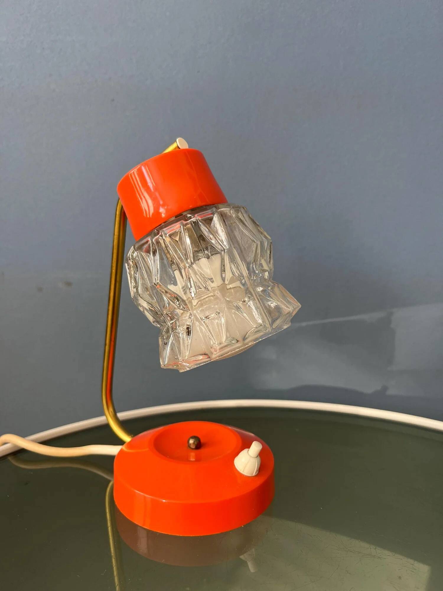 Small orange desk lamp with clear crystal glass shade