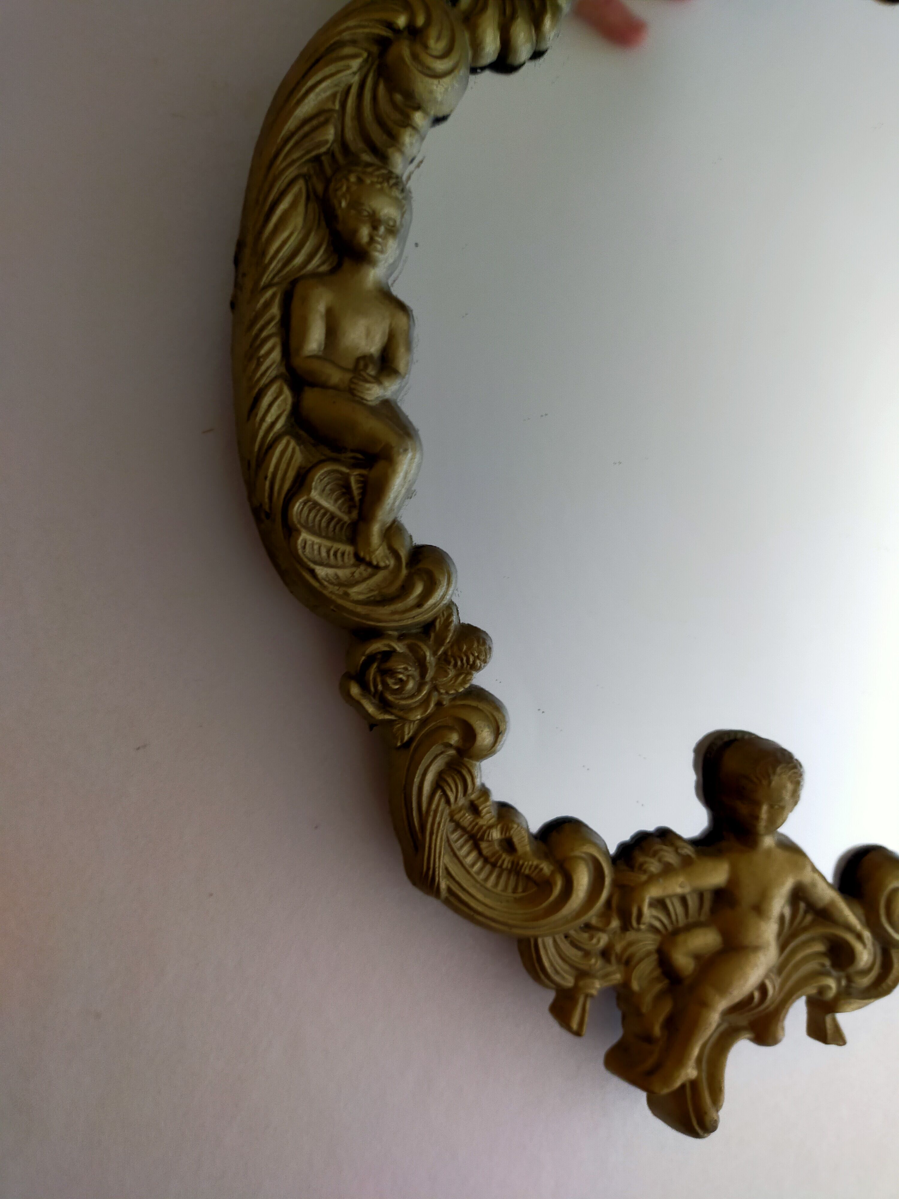 Gilded bronze mirror with angels and scrolls