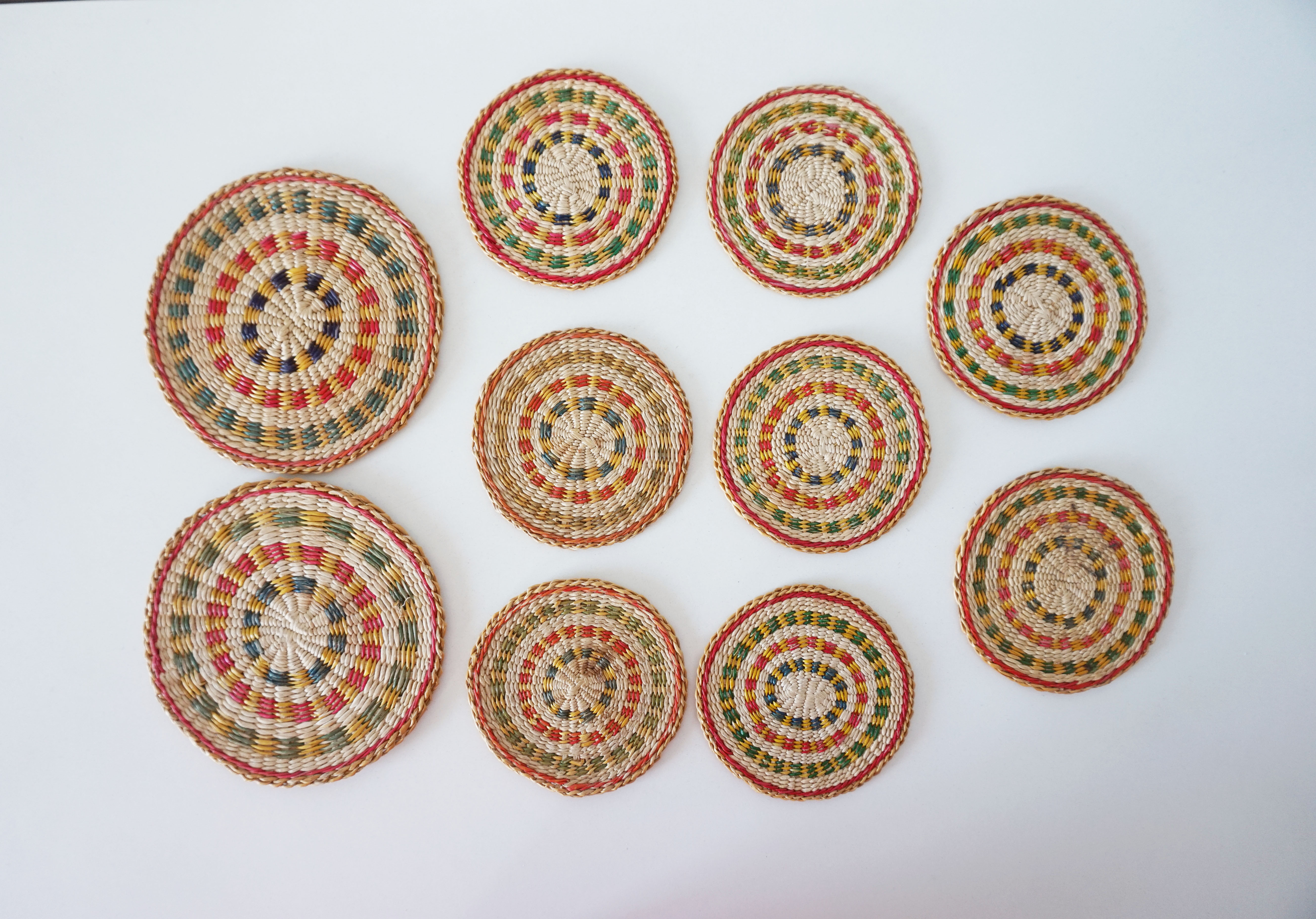 Set of coasters and bottles in colored wicker