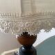 Small vintage wooden turned table lamp with a pleated shade.