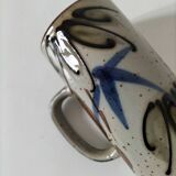 Glazed stoneware mug with free decoration, vintage pottery work.