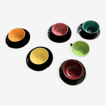 Coffee service composed of 5 cups and saucers in black earthenware and different colored interiors