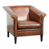Fauteuil en peau de mouton au design Art Déco avec passepoil noir.