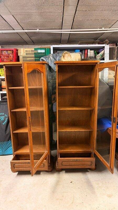 Set of 2 solid wood display cabinets with glass doors.