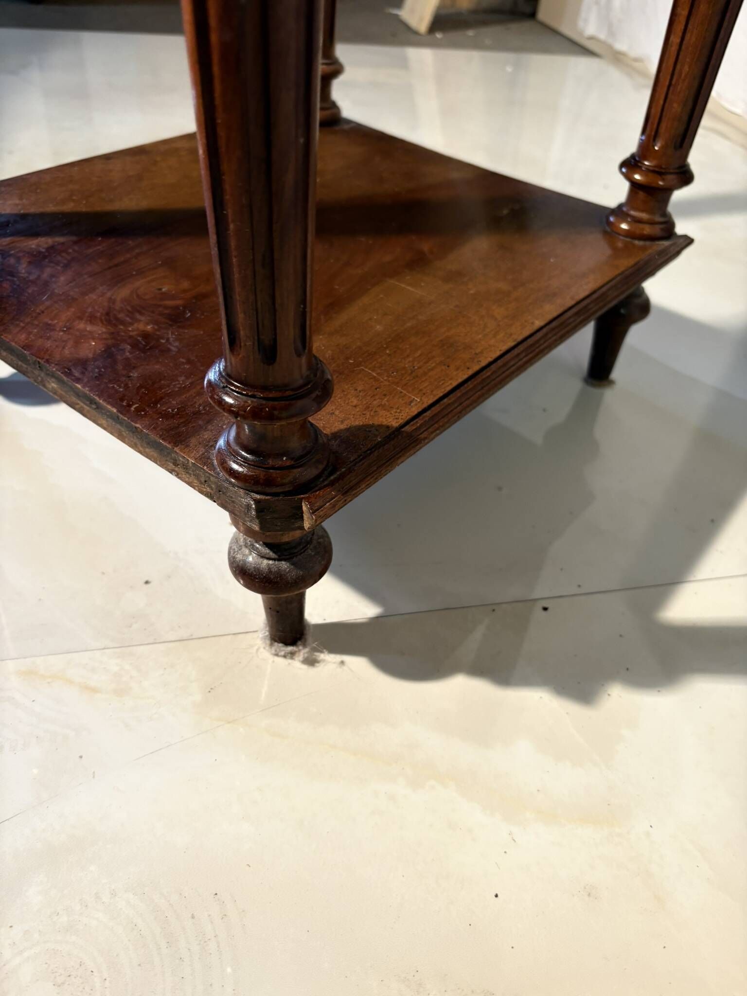 Antique wooden bedside table with turned legs.