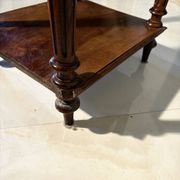 Antique wooden bedside table with turned legs.