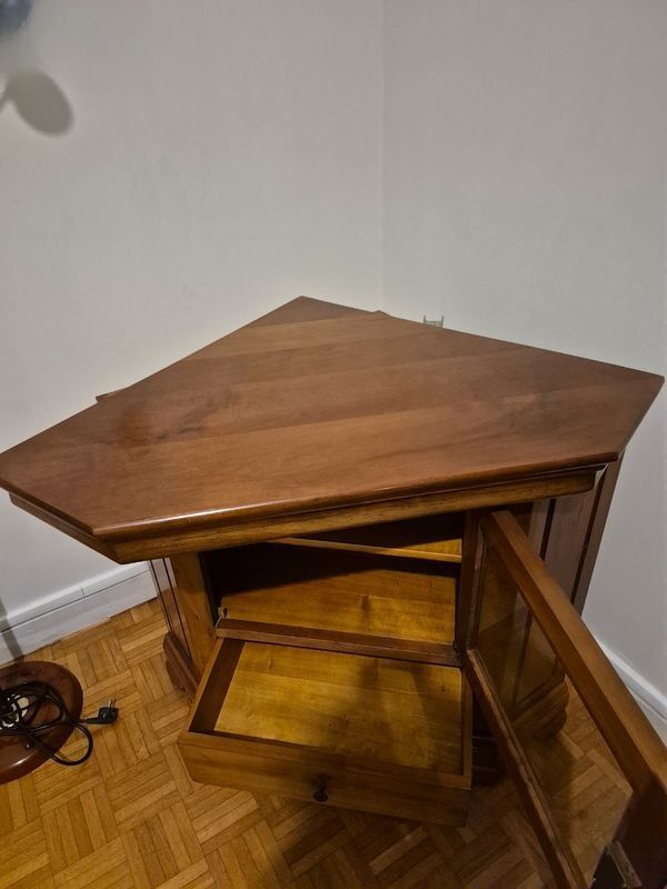 Wooden TV unit with a rotating top.