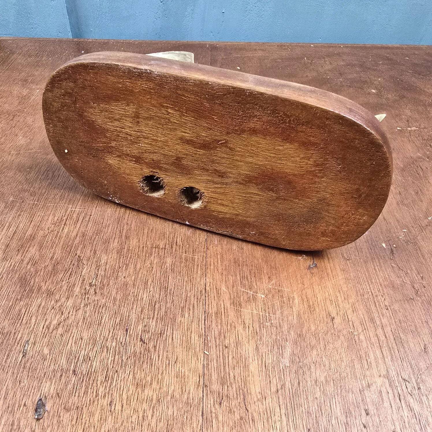 Vintage cat fish catchall in brass on a solid wood base.
