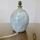 Ceramic lamp with double lighting and openwork design.