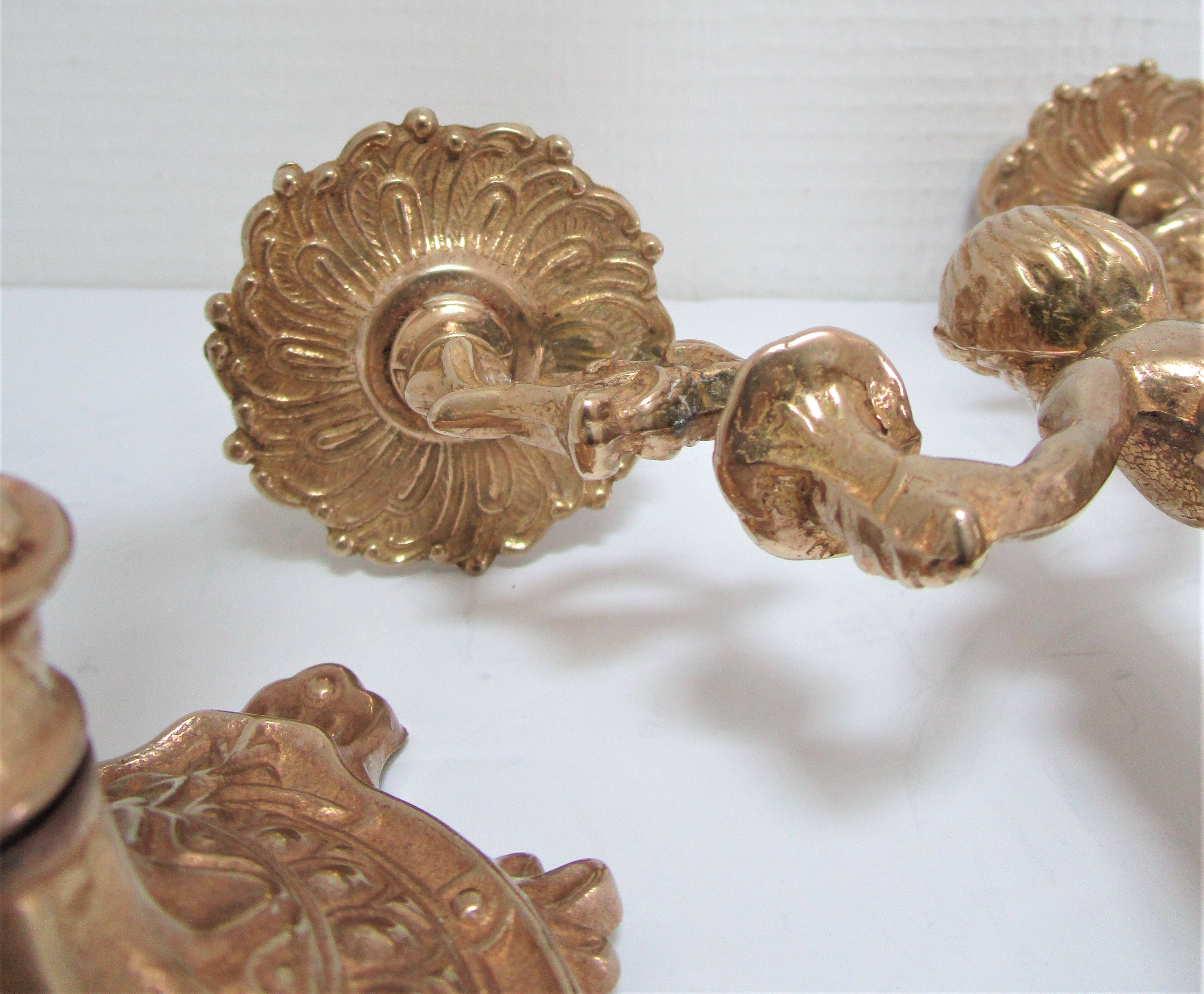 Pair of vintage golden brass cherub candlesticks