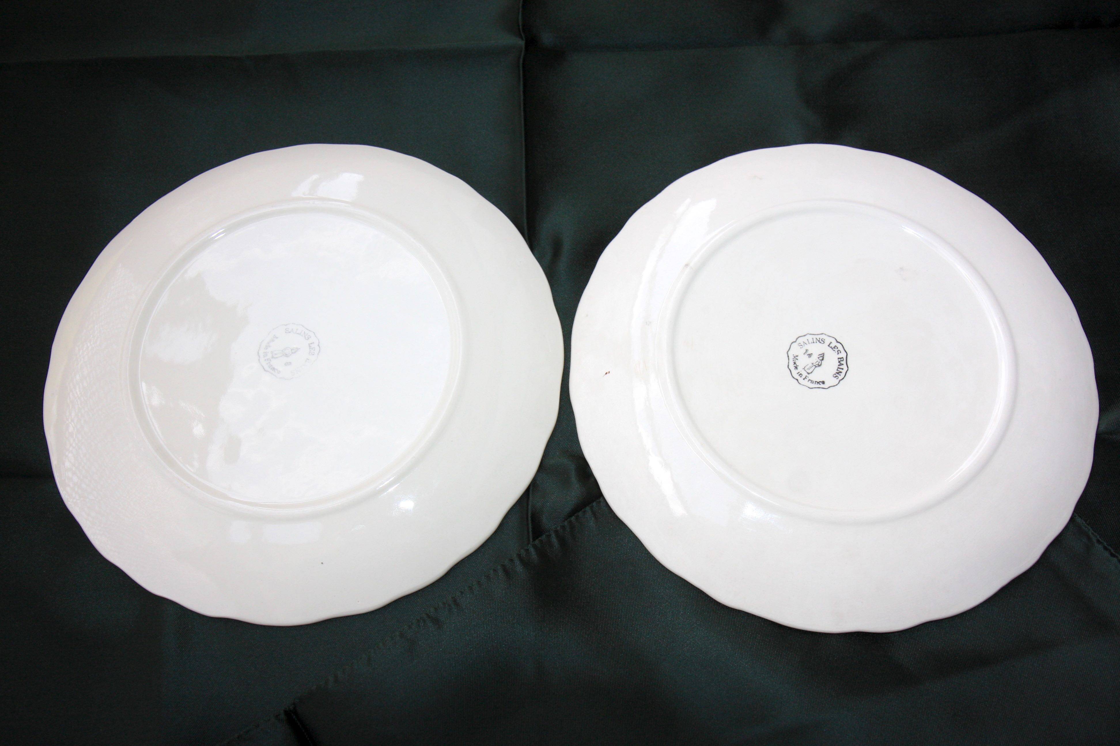 Two slip plates decorated with fruit.