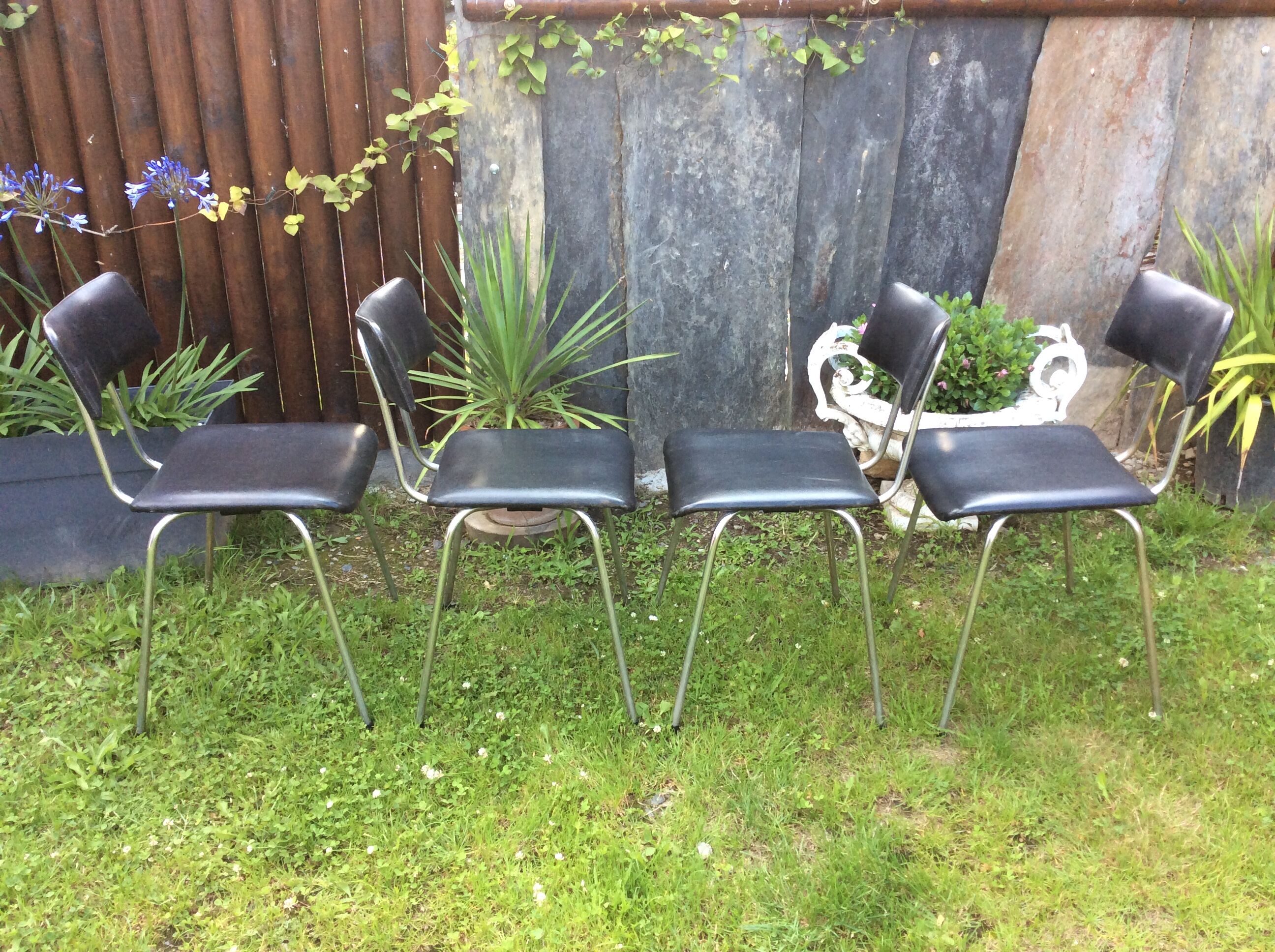 4 Chairs with chrome tubular metal base and black Skaï