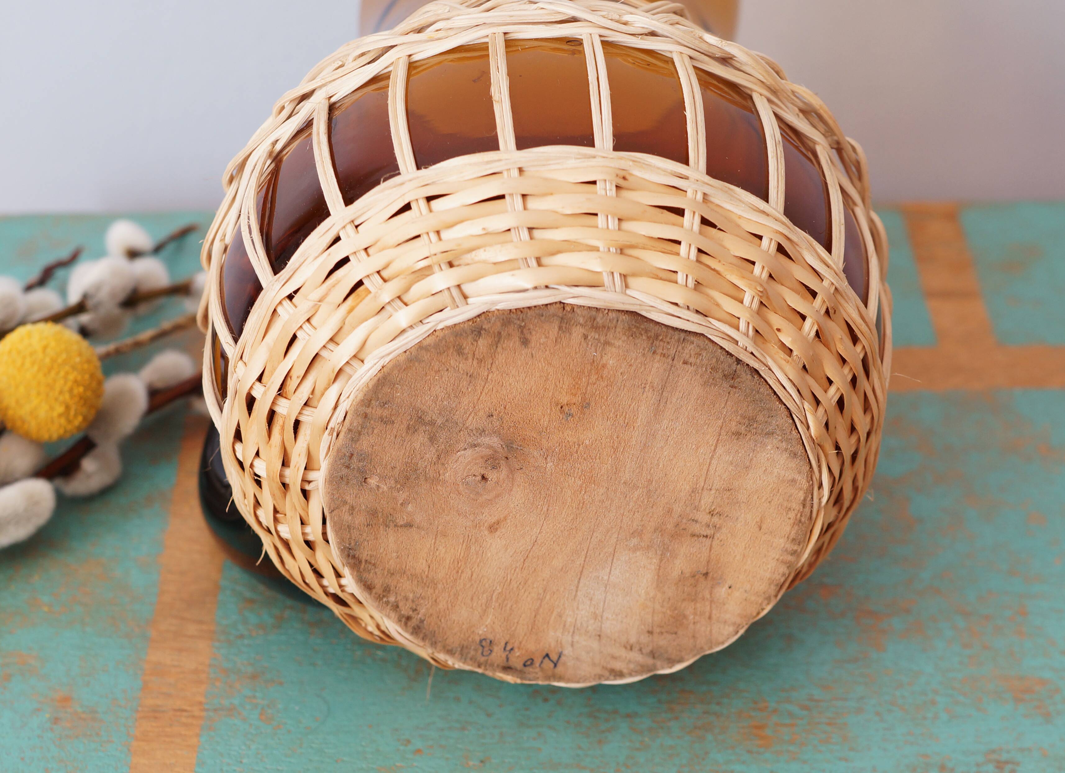 Amber glass decanter dressed in wicker, vintage