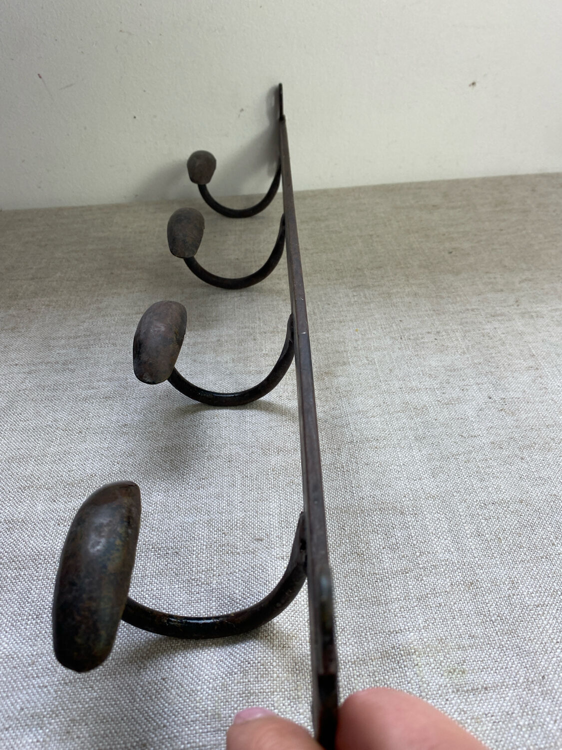 Coat rack, four hooks, in wrought iron.