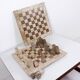 Modernist two-tone travertine chess set, Italy, 1970s