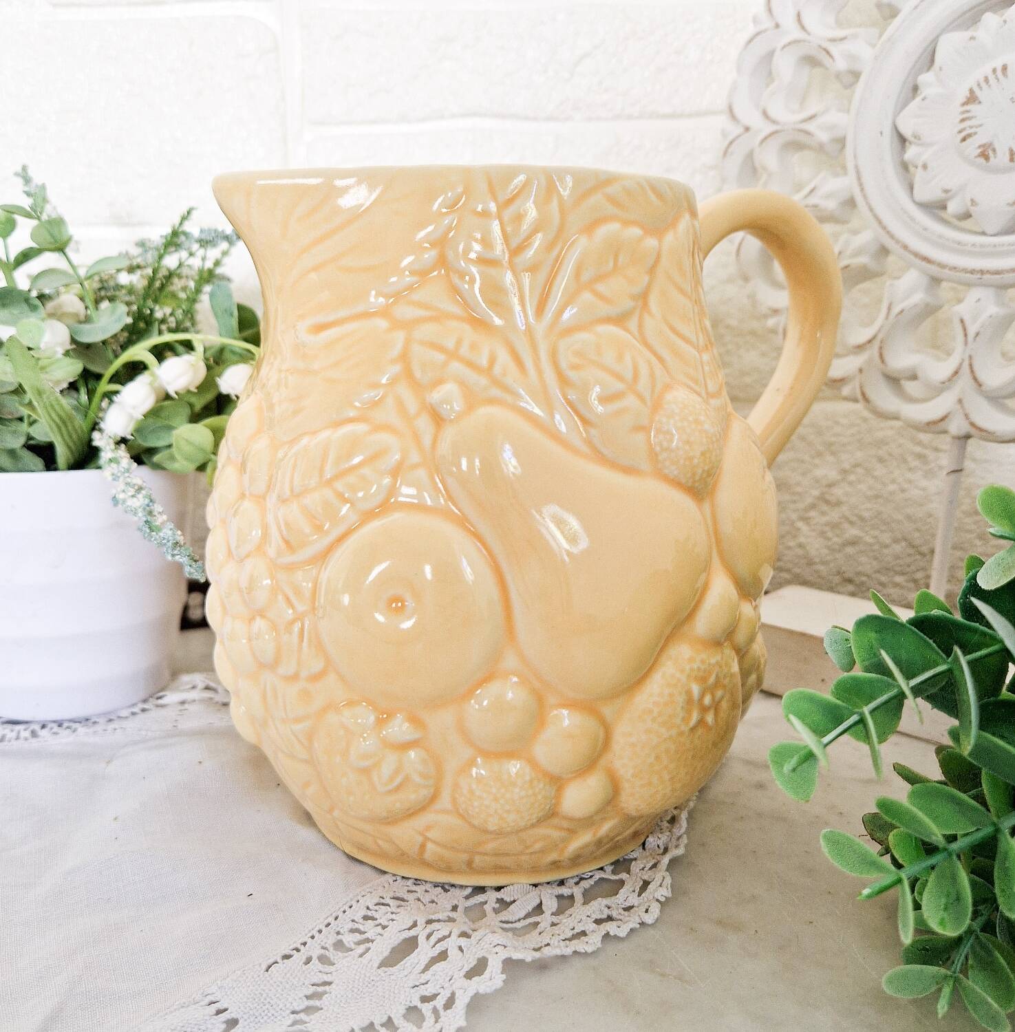Vintage yellow pitcher in fruit slip
