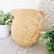 Vintage yellow pitcher in fruit slip