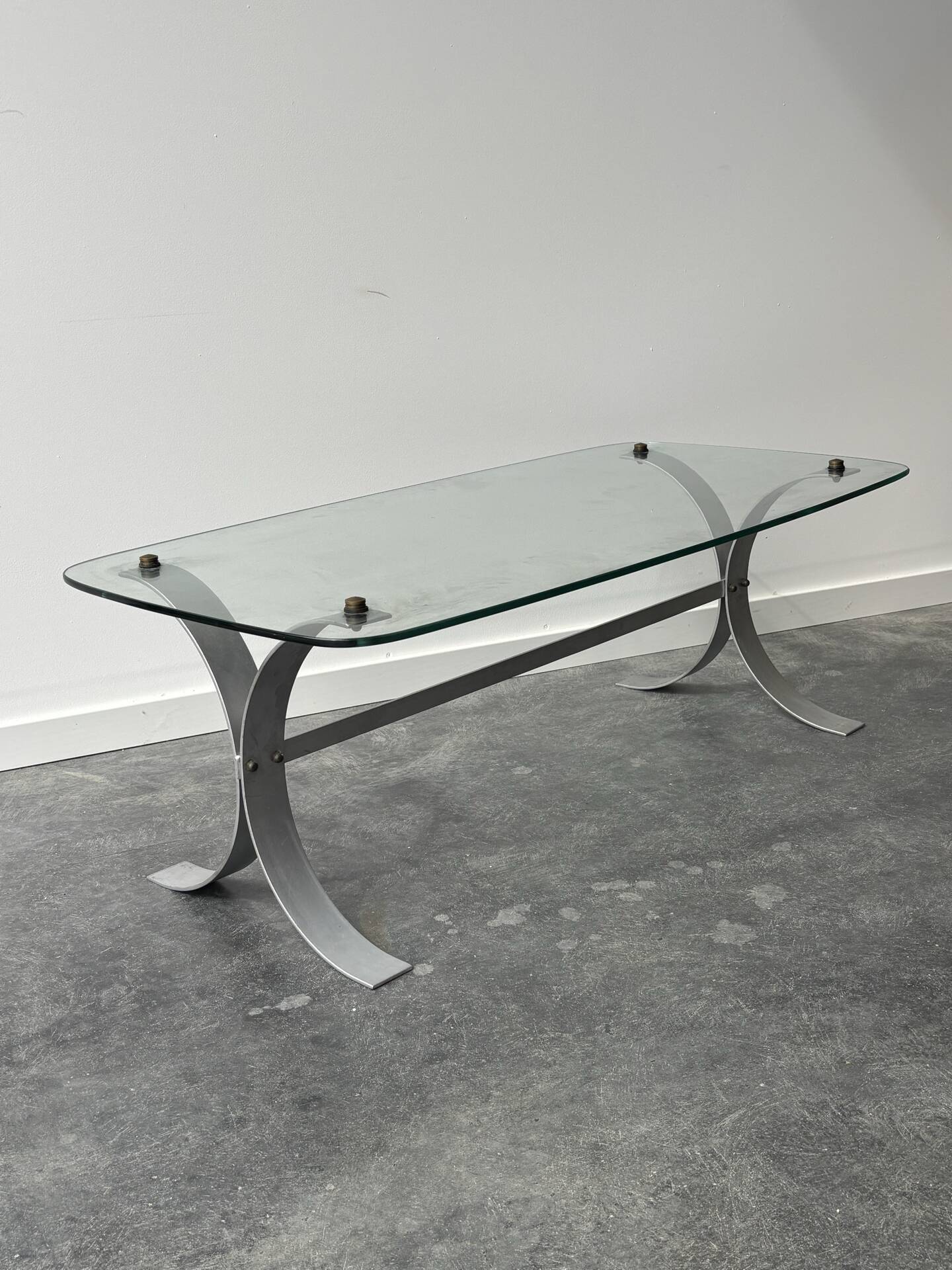 Design coffee table in brushed metal with a glass top, 1970s.