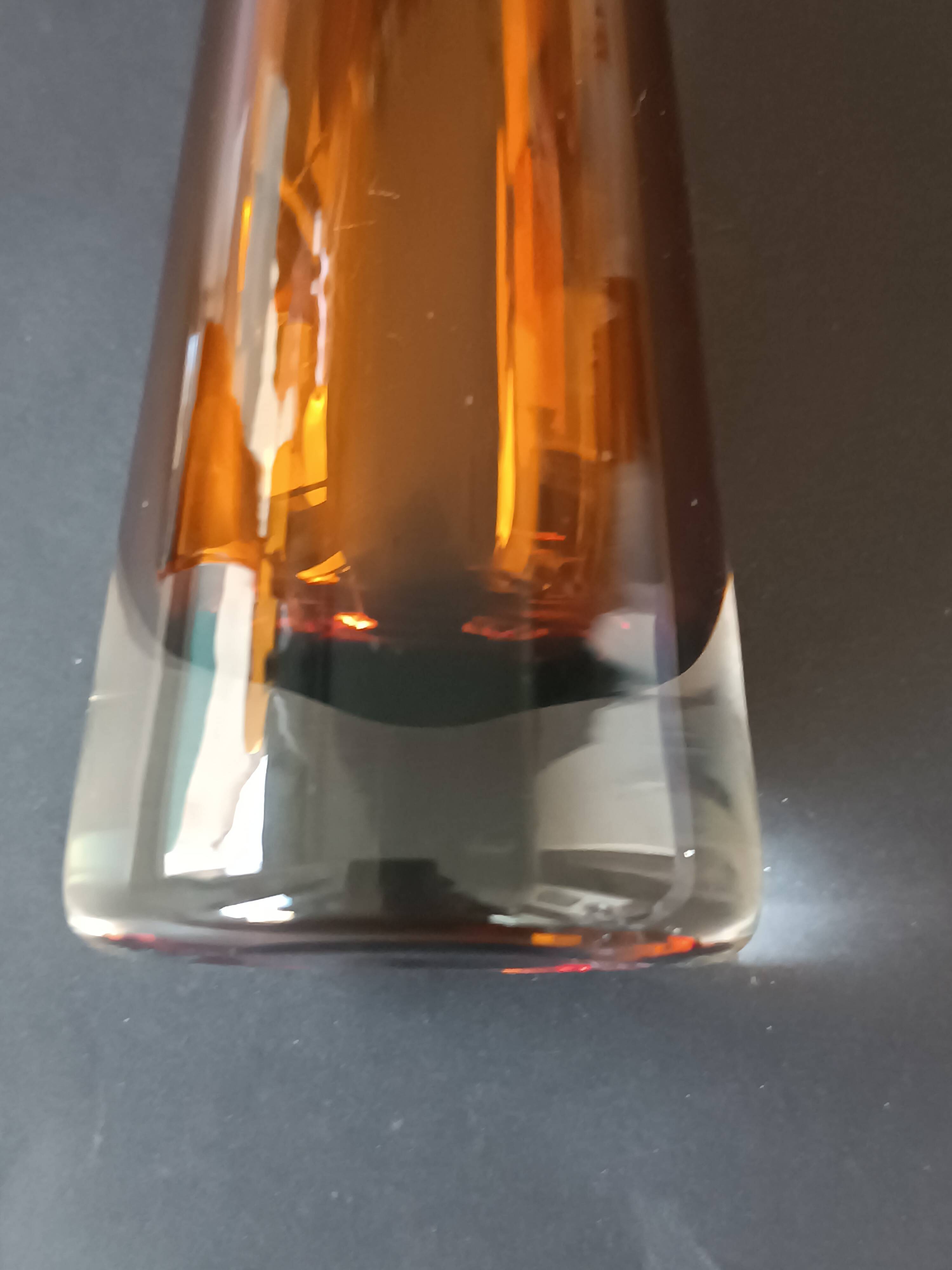 Two vintage Scandinavian double-layered amber blown glass candlesticks