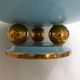 Art Deco modernist coupe, with a base of 3 spheres, in turquoise ceramic and gilding.