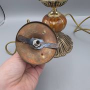 Hollywood Regency bedside lamp in gold metal with a glass globe.
