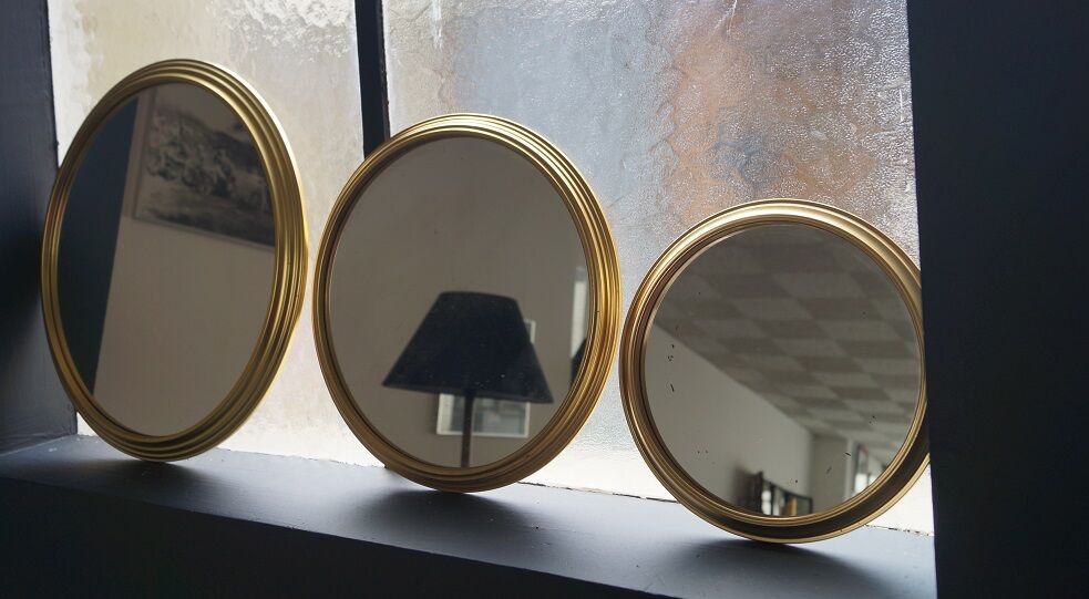 Suite of three brass mirrors