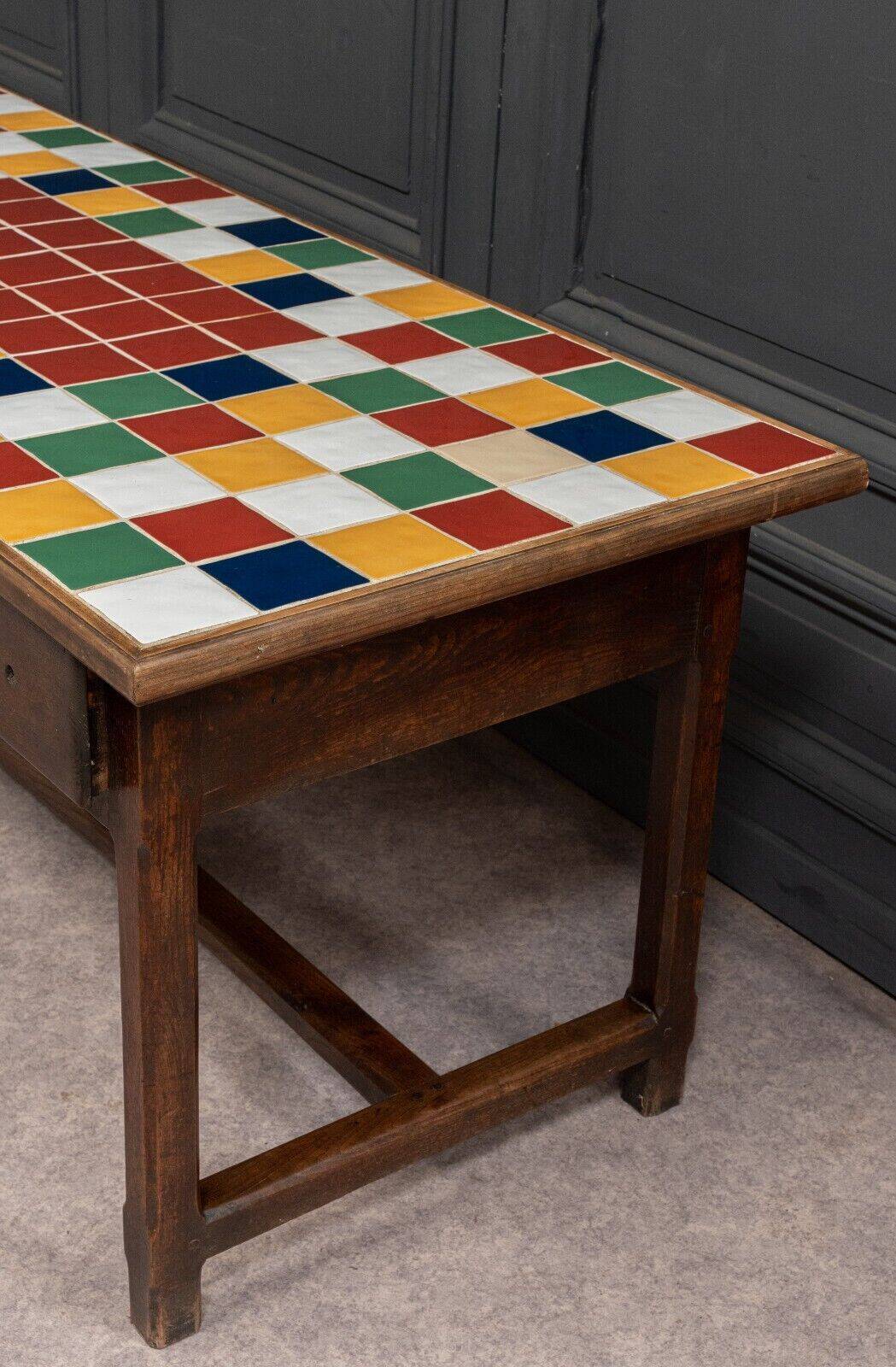 19th century oak farm table with multi-colored ceramic tiles