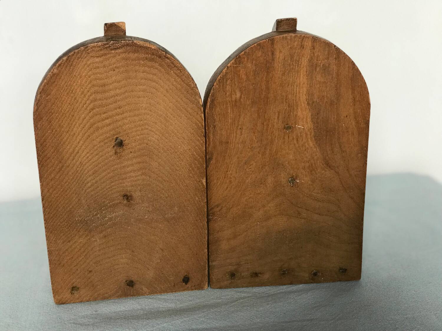 Old wooden bookends with painted characters