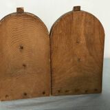 Old wooden bookends with painted characters