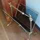 1950s bronze and tinted glass magazine rack with clawed feet
