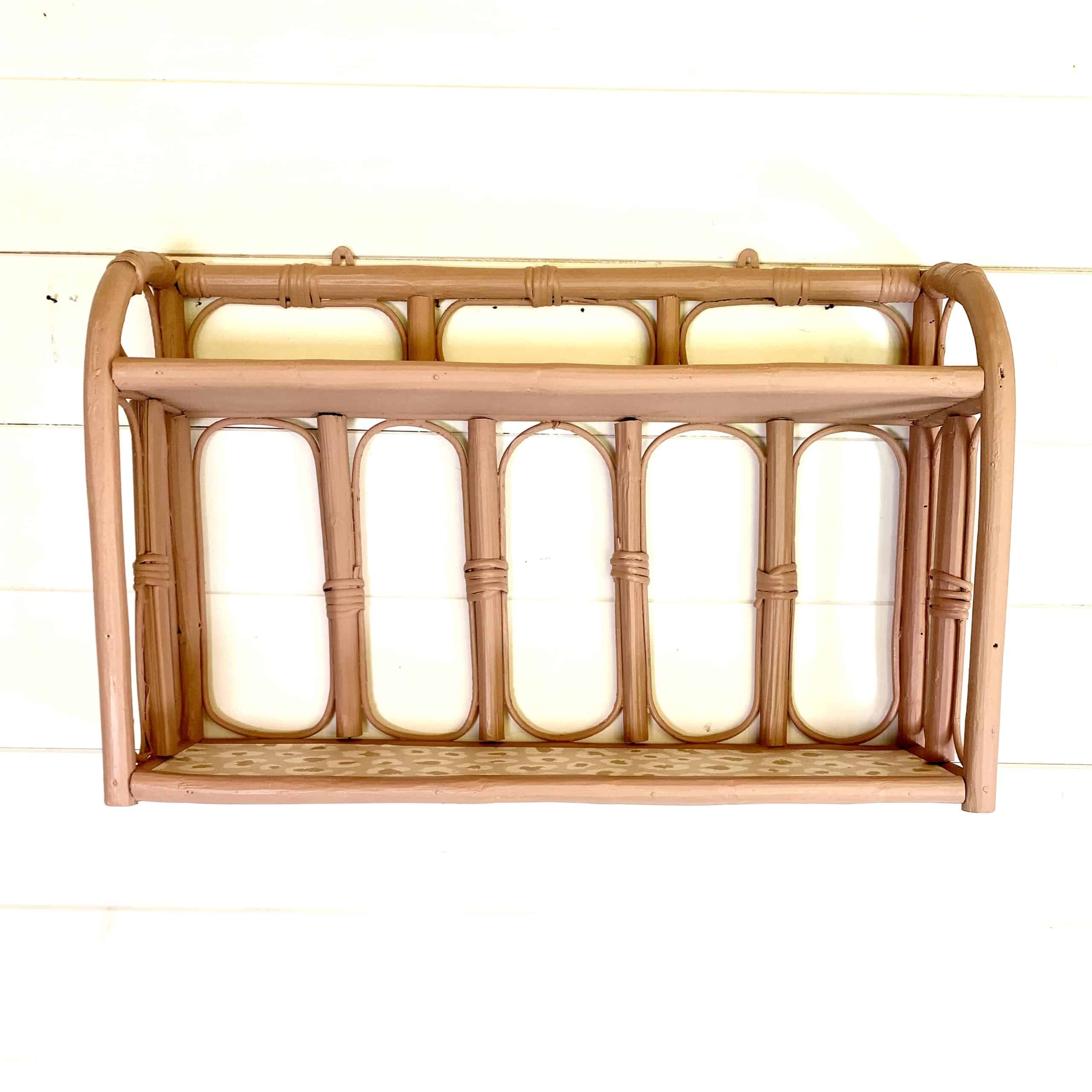 Pale pink rattan wall shelf