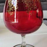 Vase in the shape of a footed cup, in bohemian crystal. ruby color. scroll & floral design with 24 c gold highlights