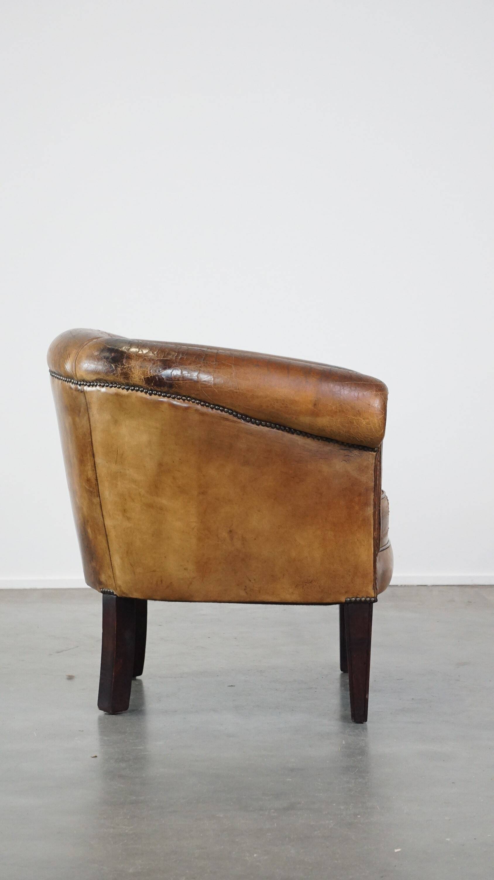 Sturdy, stately and subtle vintage sheepskin club chair