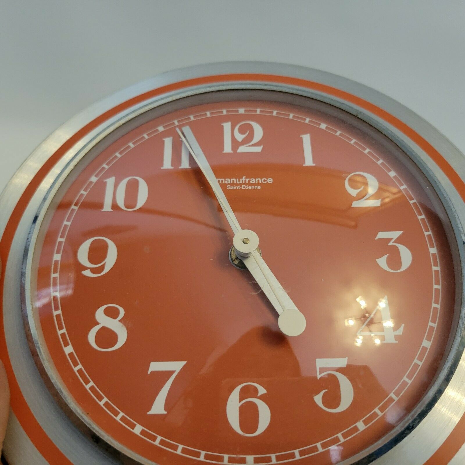 Old orange aluminum clock Manufrance Saint-Etienne
