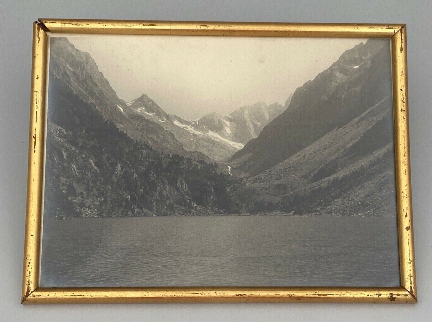 Photo in black and white mountain lake in golden frame