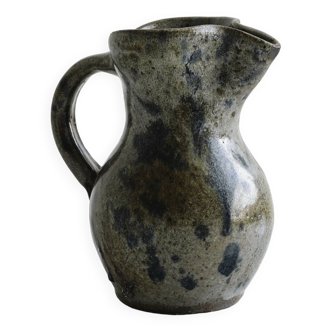 Small handcrafted ceramic pitcher with spotted enamel