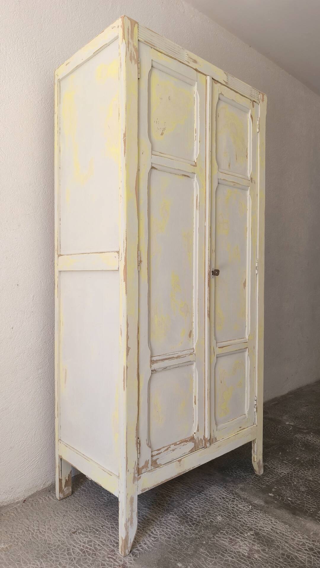 Small antique wardrobe patinated in beige and yellow.