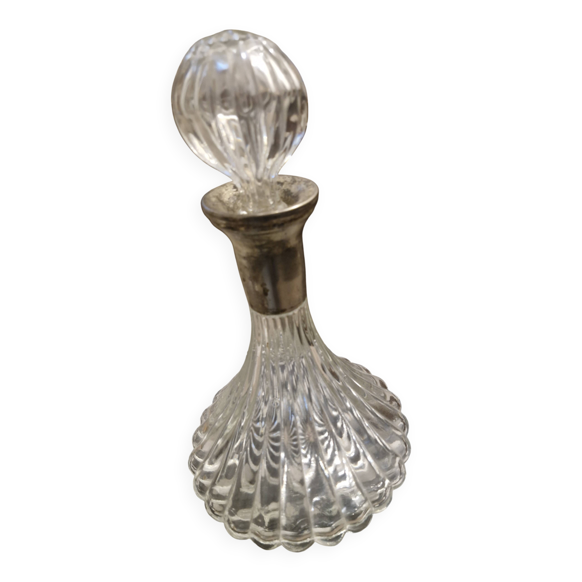 Antique cut glass spirit decanter with silver-plated neck and spout.