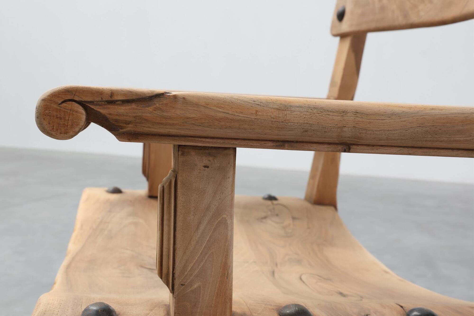 Brutalist armchair with carved rosettes and nailed wooden seat, Spain