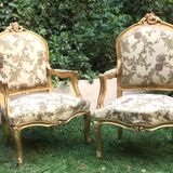 Pair of straight-backed armchairs, known as "queen's armchairs," in carved and gilded wood