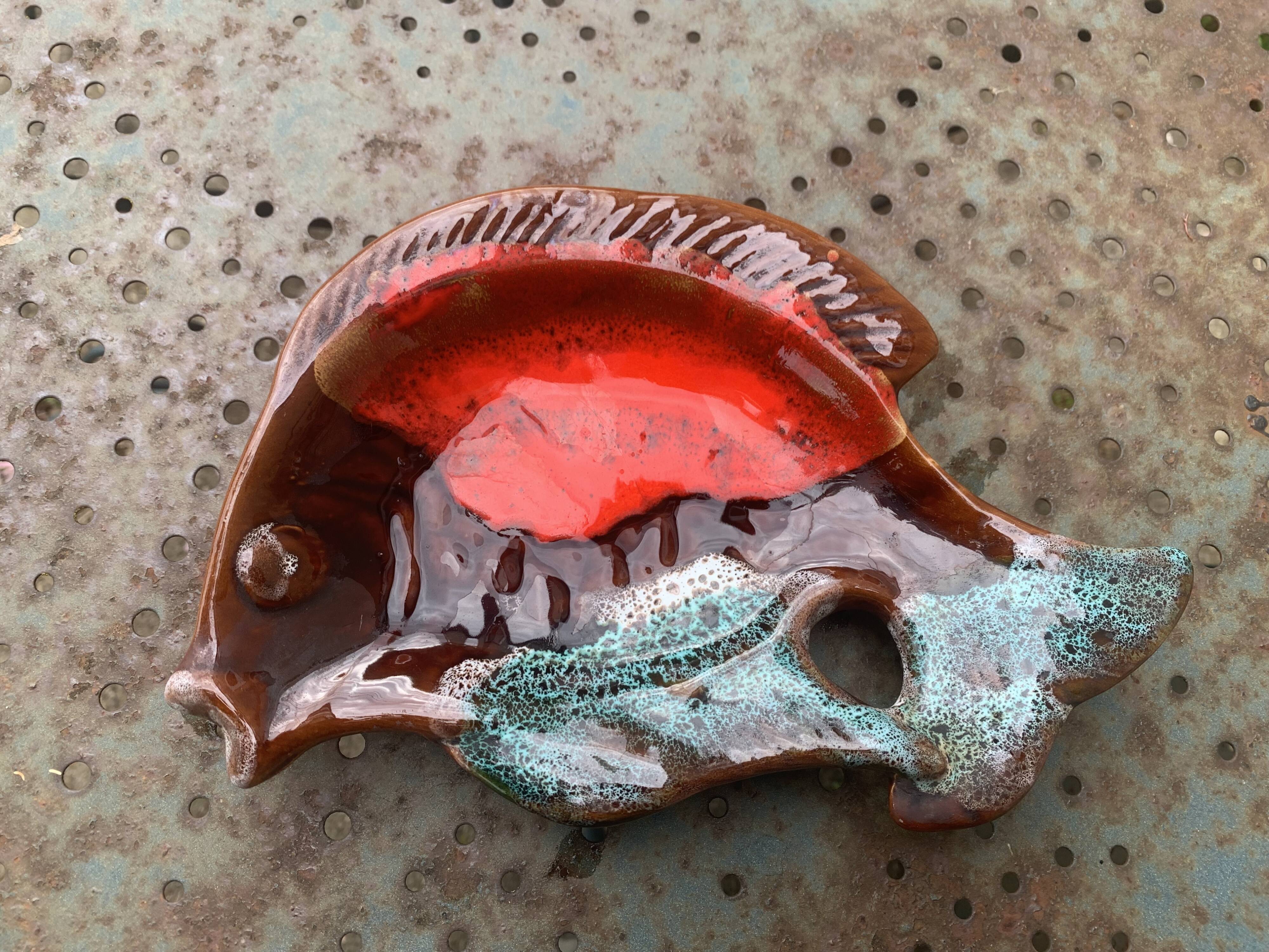 Empty pocket in glazed ceramic slip in the shape of vintage fish