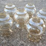 Set of 6 amber glass globes.