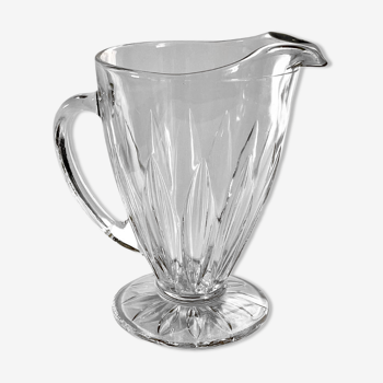 Glass pitcher on base