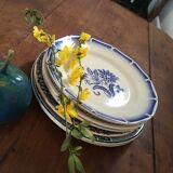 Together seven dessert plates mismatched in blue.