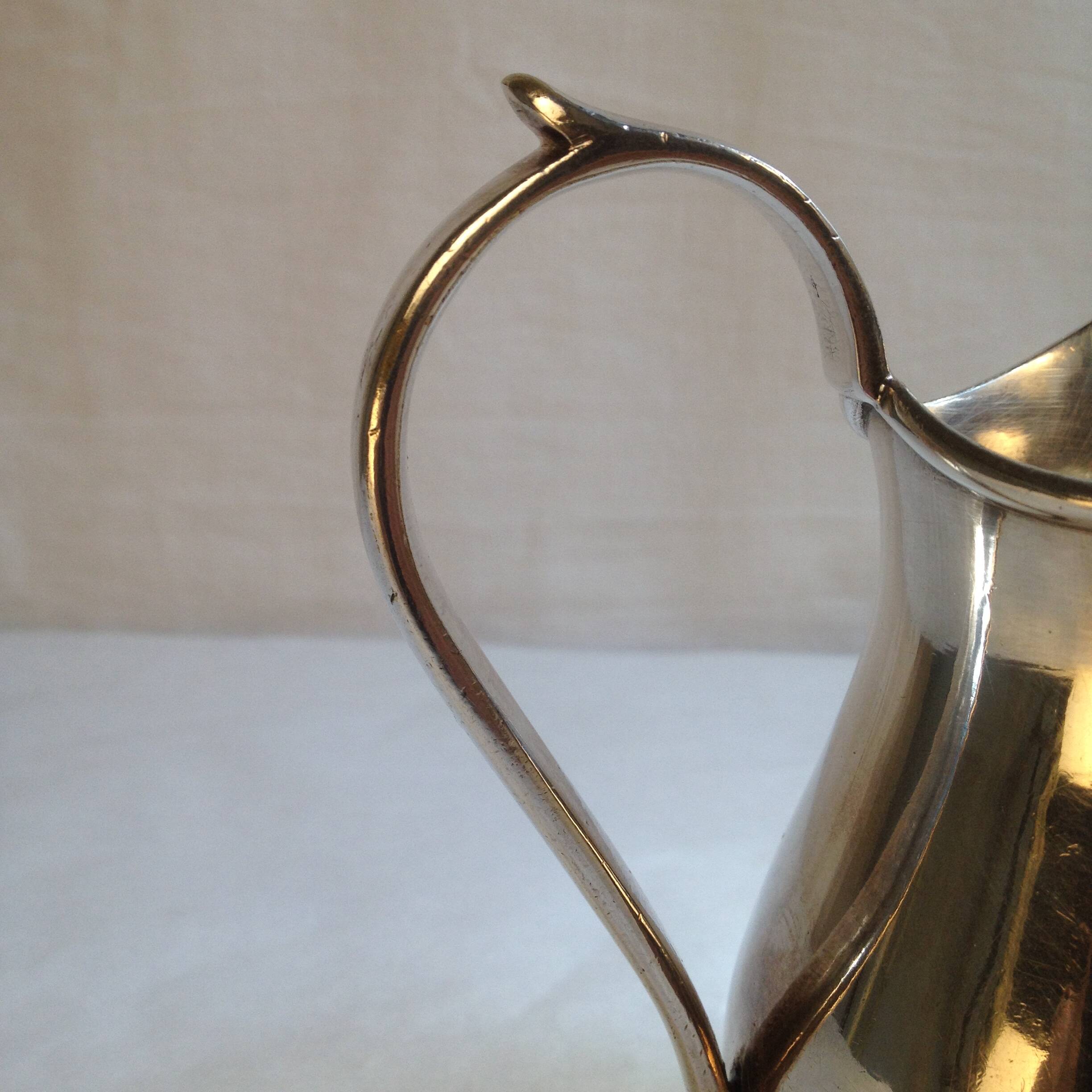 Silver metal milk jug