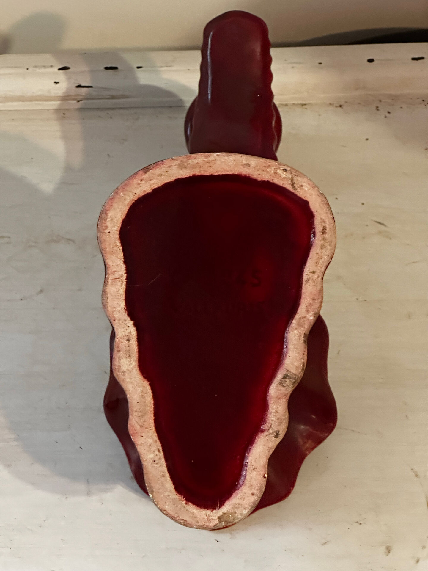Ruby red ceramic pocket ashtray from Vallauris, numbered.