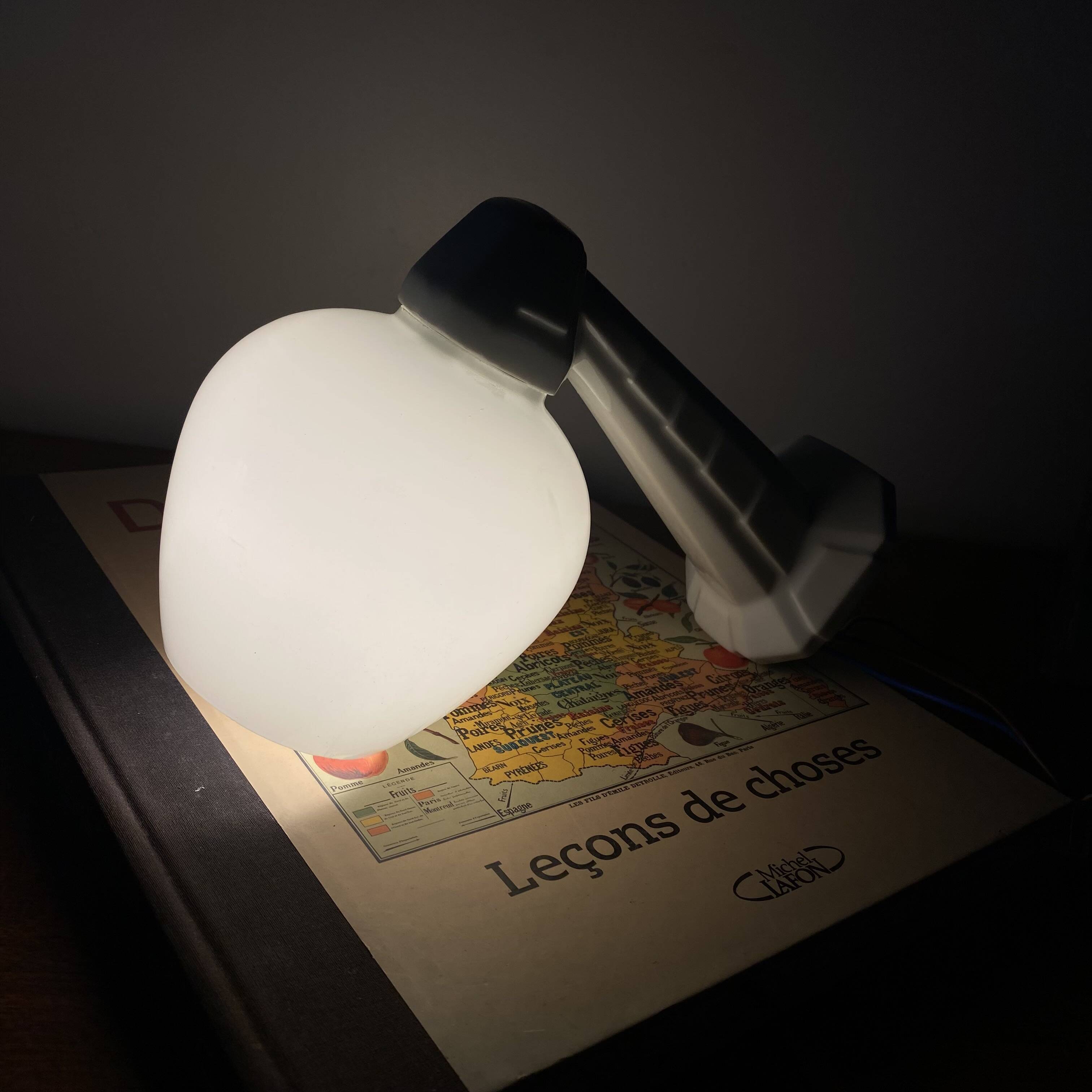 Swan neck wall light in ceramic with an opaline white glass globe.